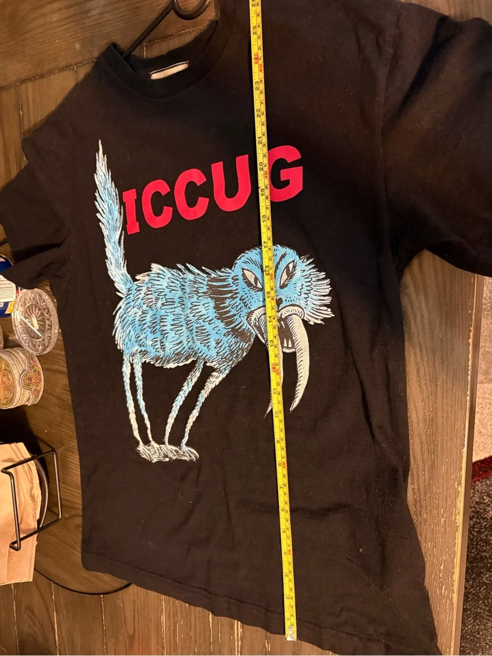 Mens Black Graphic Tee with Blue Creature and Red Logo